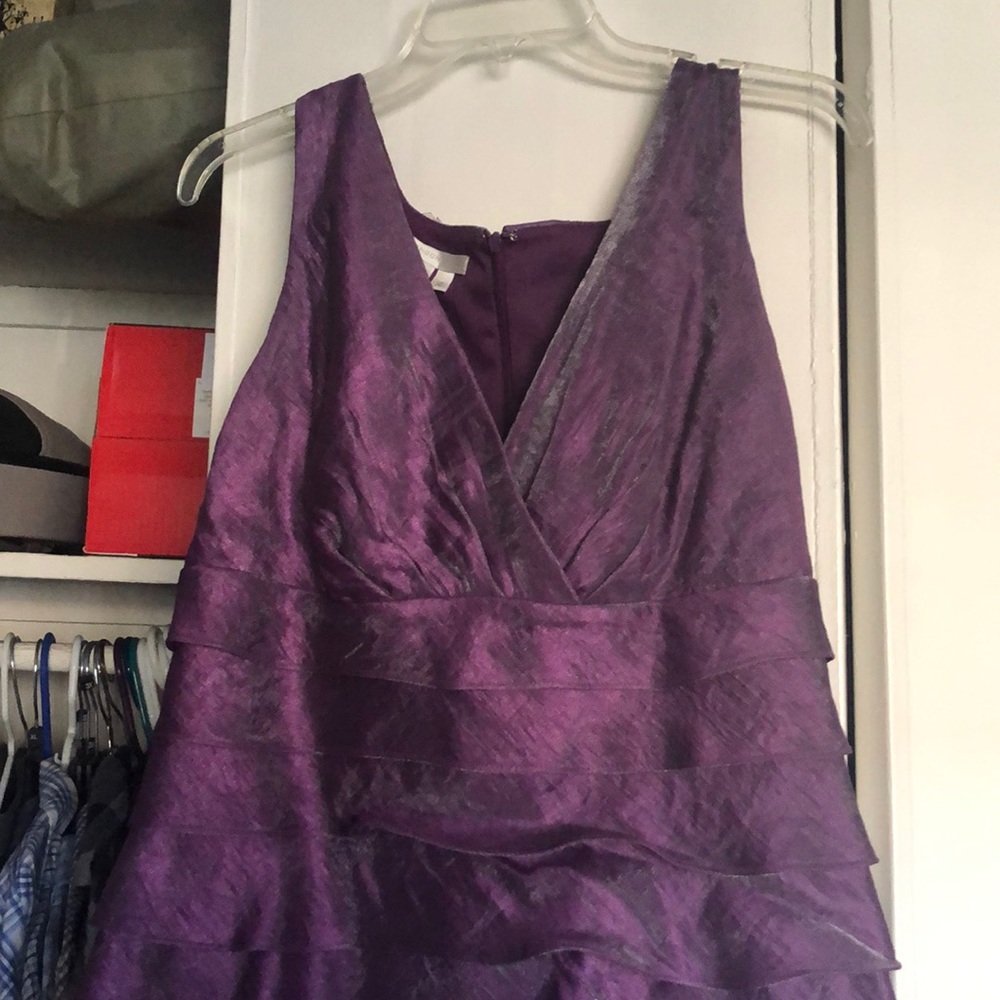 Purple dress with v neck top.